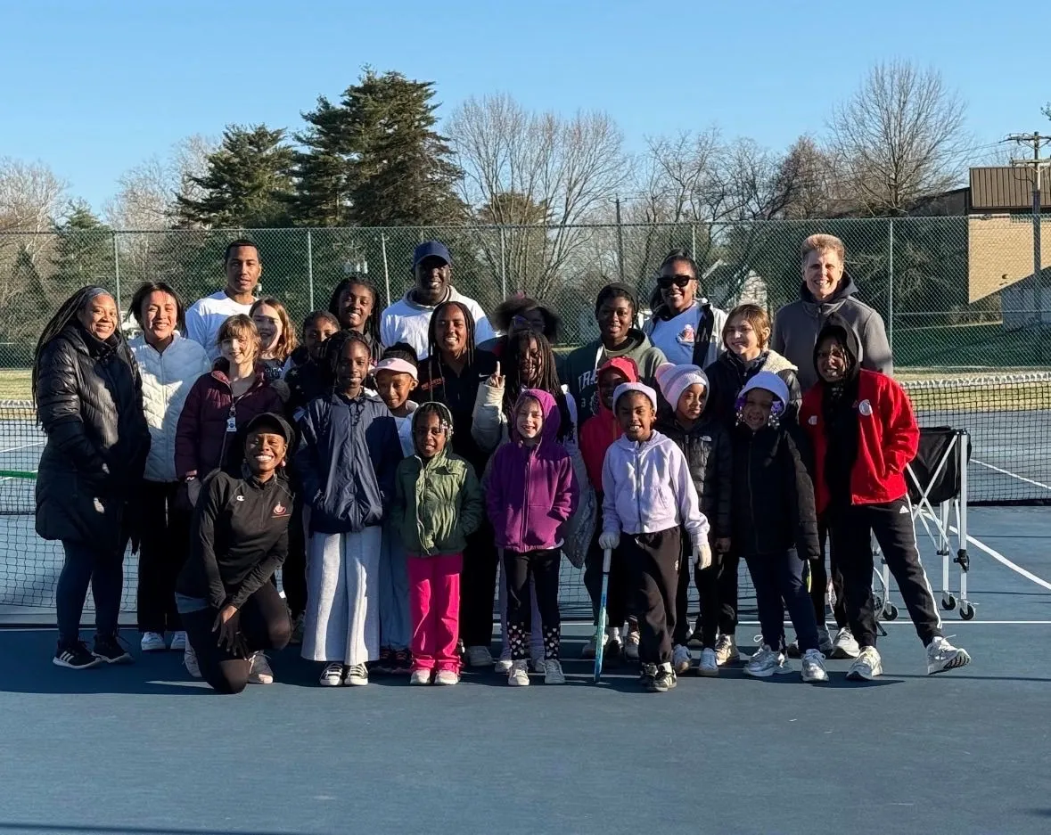 Girls Got Game tennis clinic participants gathered on court with coaches and guests