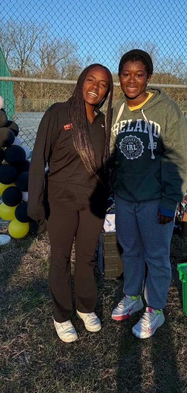 A young tennis participant with a mentor at the Spring 2026 event