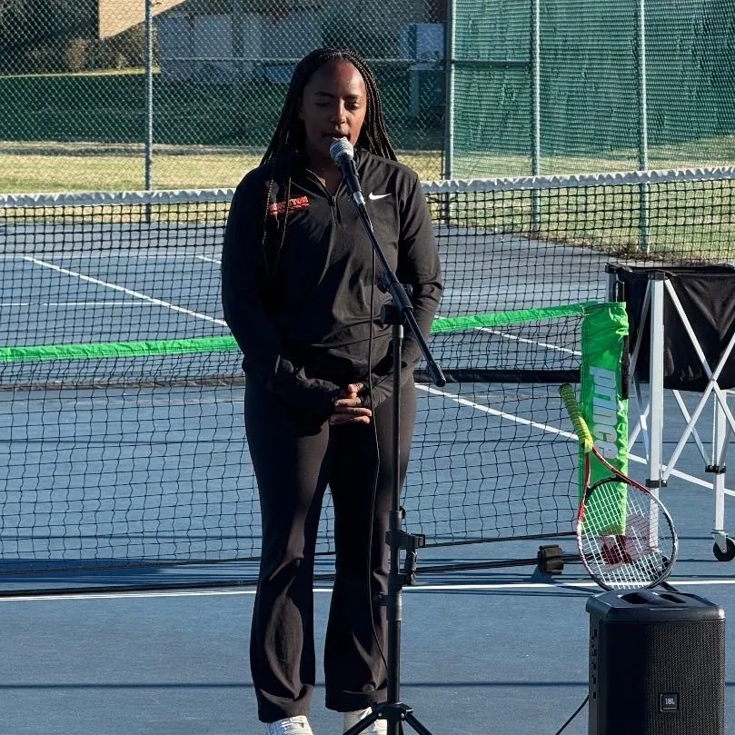 A speaker addressing girls during the Spring 2026 Girls Got Game Tennis Edition
