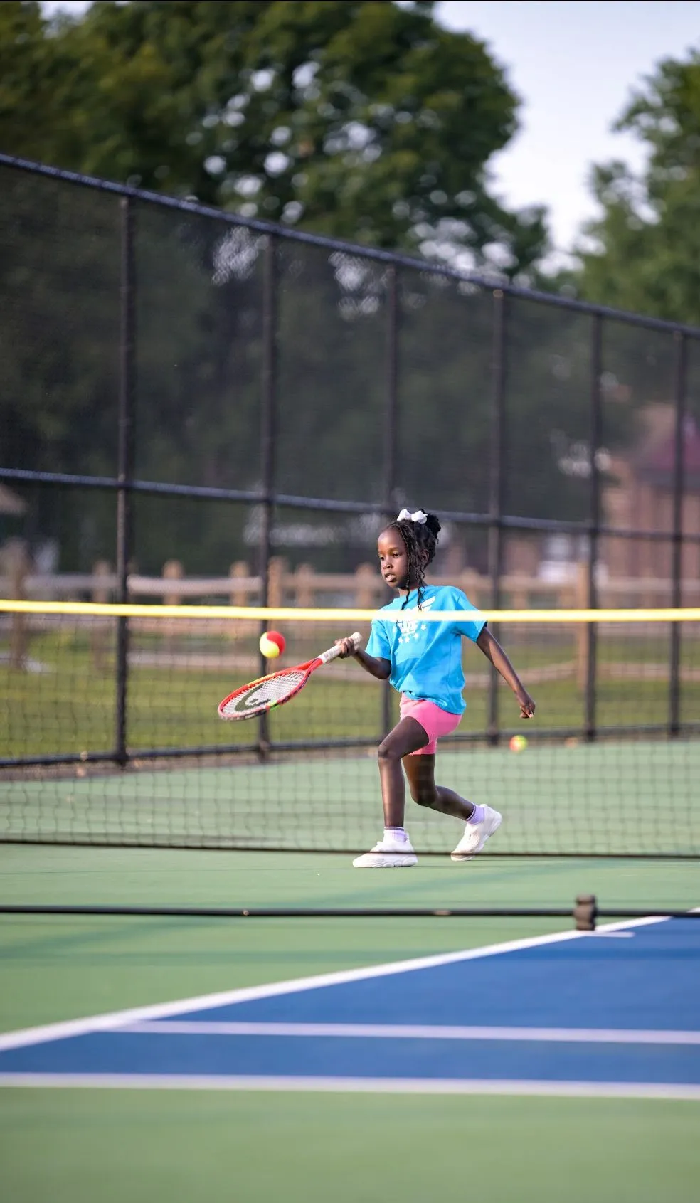 Girls standing together on the tennis court