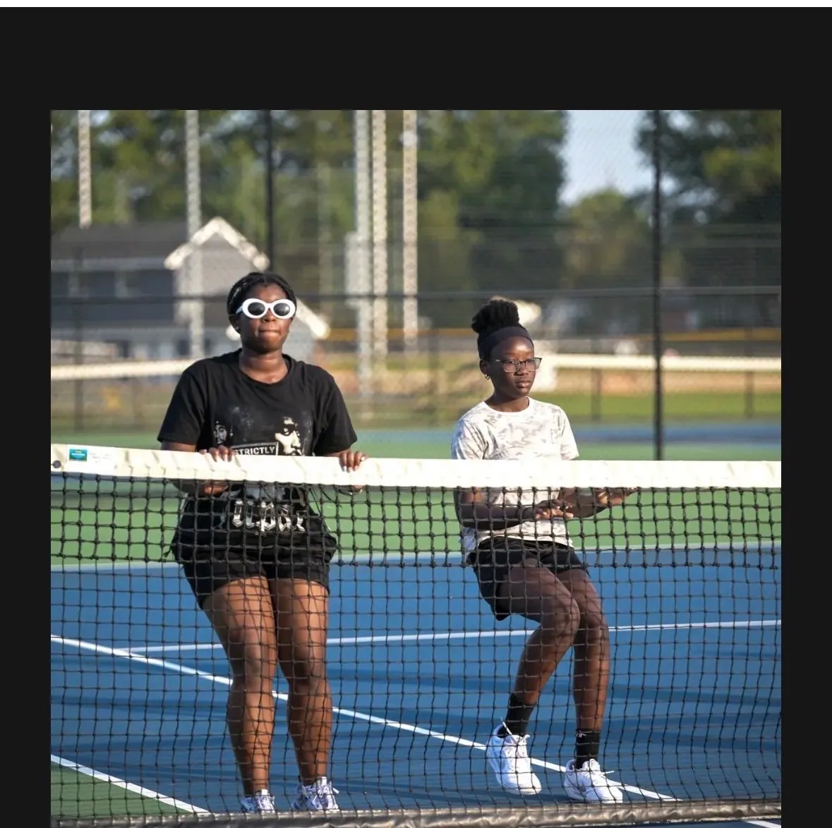 Two girls sharing a moment at the net