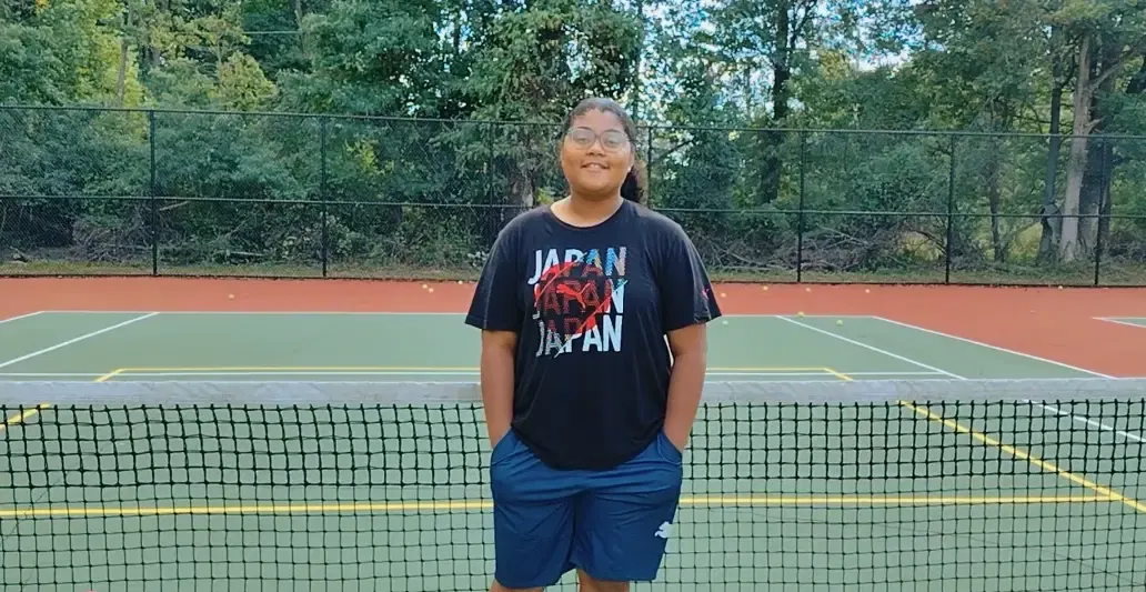 A young tennis player on court